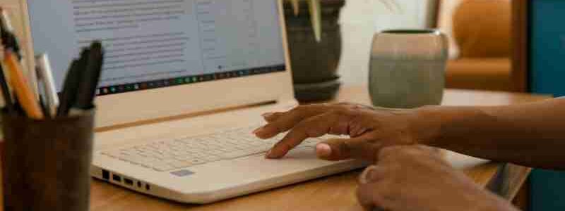 Hands typing on a laptop on a desk indoors with a mug and phone nearby., tags: moderne - pexel